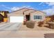 One-story house with a two-car garage and landscaping at 670 E Wiley Way, Casa Grande, AZ 85122