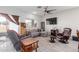 Cozy living room featuring a gray sectional and leather chair at 670 E Wiley Way, Casa Grande, AZ 85122