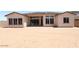 View of the rear exterior of home showing large windows and sliding doors, along with an expansive backyard at 6818 N 190Th Ave, Waddell, AZ 85355
