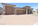 Beautiful single-story home featuring a 3-car garage, stone accents, and a paver driveway at 6818 N 190Th Ave, Waddell, AZ 85355