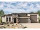 Craftsman style home with stone accents and two-car garage at 6818 N 190Th Ave, Waddell, AZ 85355