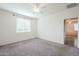 Spacious bedroom featuring a window with blinds and ceiling fan at 7225 W Jones Ave, Phoenix, AZ 85043