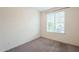 Bright bedroom with carpet flooring and large window at 7225 W Jones Ave, Phoenix, AZ 85043