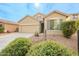 Tan house with gray shutters, two-car garage, and landscaped front yard at 7225 W Jones Ave, Phoenix, AZ 85043