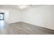 Bright hallway with wood-look flooring and access to other rooms at 7225 W Jones Ave, Phoenix, AZ 85043