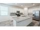 Spacious kitchen with white cabinets, granite island, and stainless steel appliances at 7225 W Jones Ave, Phoenix, AZ 85043