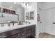 Double vanity bathroom with modern fixtures and large mirror at 7332 S Briarwood Ln, Gilbert, AZ 85298