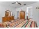 Bedroom with wooden dresser, built-in wardrobe, and patterned bedding at 7332 S Briarwood Ln, Gilbert, AZ 85298