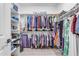 Walk-in closet with ample shelving and hanging space for clothes at 7332 S Briarwood Ln, Gilbert, AZ 85298