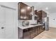 Modern kitchen with dark wood cabinets and stainless steel appliances at 7332 S Briarwood Ln, Gilbert, AZ 85298