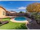 Artificial turf, kidney-shaped pool, and patio furniture at 741 W Harvest Rd, San Tan Valley, AZ 85140