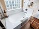 Soaking tub with glass block window at 741 W Harvest Rd, San Tan Valley, AZ 85140