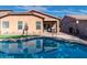 Tan house exterior with covered patio and pool view at 741 W Harvest Rd, San Tan Valley, AZ 85140