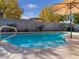 Relaxing pool with patio furniture and umbrellas in a sunny backyard at 741 W Harvest Rd, San Tan Valley, AZ 85140