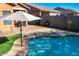 Large inviting pool with patio furniture and umbrellas at 741 W Harvest Rd, San Tan Valley, AZ 85140