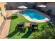 Relaxing pool area with lounge chairs and patio umbrellas at 741 W Harvest Rd, San Tan Valley, AZ 85140