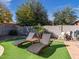 Relaxing poolside lounge chairs on artificial turf at 741 W Harvest Rd, San Tan Valley, AZ 85140