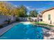 Sparkling blue kidney-shaped swimming pool in backyard at 741 W Harvest Rd, San Tan Valley, AZ 85140