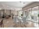 Elegant dining area with glass top table and white chairs, near the living room at 8687 E Tuckey Ln, Scottsdale, AZ 85250