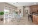 Bright dining room with glass table, white chairs, and access to a patio at 8687 E Tuckey Ln, Scottsdale, AZ 85250