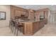 Spacious kitchen featuring an island, wood cabinetry, and granite countertops at 8687 E Tuckey Ln, Scottsdale, AZ 85250