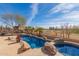 Luxury pool and spa with flagstone decking at 8687 E Tuckey Ln, Scottsdale, AZ 85250