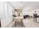 Bright dining area with wooden table and white chairs near living room at 880 E Verde Blvd, Queen Creek, AZ 85140