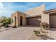 Tan house with a two-car garage and landscaped front yard at 880 E Verde Blvd, Queen Creek, AZ 85140