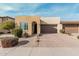 Tan house with a two-car garage and landscaped front yard at 880 E Verde Blvd, Queen Creek, AZ 85140