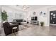 Living room with gray sofa and a large TV at 880 E Verde Blvd, Queen Creek, AZ 85140