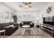 Living room with gray sofa and a large TV at 880 E Verde Blvd, Queen Creek, AZ 85140