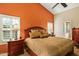 Cozy bedroom with a ceiling fan, wood furniture, and large windows at 8947 E Mescal St, Scottsdale, AZ 85260