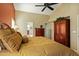 Bright bedroom with ceiling fan, large bed, and ample closet space at 8947 E Mescal St, Scottsdale, AZ 85260