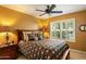 Bedroom with ceiling fan, large bed, and window with shutters at 8947 E Mescal St, Scottsdale, AZ 85260