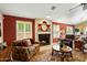 Living room featuring a fireplace, leather furniture, and a large window at 8947 E Mescal St, Scottsdale, AZ 85260