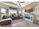 Living room with L-shaped sofa and a fireplace at 906 N Swan Dr, Gilbert, AZ 85234