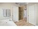 Bathroom with soaking tub, shower, and neutral color palette at 9230 N 104Th Pl, Scottsdale, AZ 85258