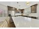 Close up of a bright kitchen with large island, stainless steel appliances, white countertops and backsplash at 9230 N 104Th Pl, Scottsdale, AZ 85258