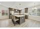 Bright kitchen featuring stainless steel appliances, grey cabinets, a large island, and plantation shutters at 9230 N 104Th Pl, Scottsdale, AZ 85258