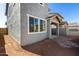 Exterior view of backyard, home windows, and access to a covered parking space at 9350 E Sequence Ave, Mesa, AZ 85212