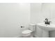 Stylish half bath features a modern pedestal sink and toilet in a bright space at 9350 E Sequence Ave, Mesa, AZ 85212