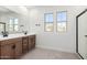 Bathroom featuring a double vanity and a large mirror at 9350 E Sequence Ave, Mesa, AZ 85212