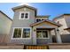 Two-story home with a covered porch, stucco exterior, a brown roof, and white-framed windows at 9350 E Sequence Ave, Mesa, AZ 85212