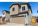 View of a gray two-story home with a two-car garage and desert landscaping at 9350 E Sequence Ave, Mesa, AZ 85212