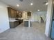 Modern kitchen featuring an island and dark brown cabinetry at 9350 E Sequence Ave, Mesa, AZ 85212