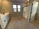 Bathroom with white cabinets, quartz countertop, and frameless shower at 9358 E Sequence Ave, Mesa, AZ 85212