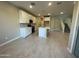 Modern kitchen featuring white cabinets, center island, and tile floors at 9358 E Sequence Ave, Mesa, AZ 85212