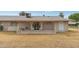 Rear view of house showing patio and surrounding yard at 10429 W Roundelay Cir, Sun City, AZ 85351