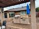 Outdoor kitchen and dining area with built in grill and pergola at 1310 E Gemini Dr, Tempe, AZ 85283