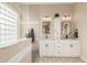 Elegant bathroom with double sinks, granite counters, and a large walk-in shower at 18193 W Buckhorn Dr, Goodyear, AZ 85338